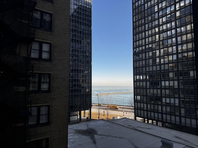 property's view of city featuring a water view and a beach view