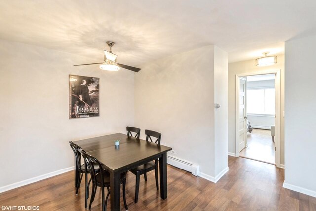 dining room with ceiling fan, dark wood-type flooring, and a baseboard radiator