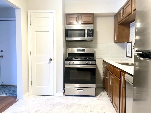 kitchen featuring stainless steel appliances and decorative backsplash