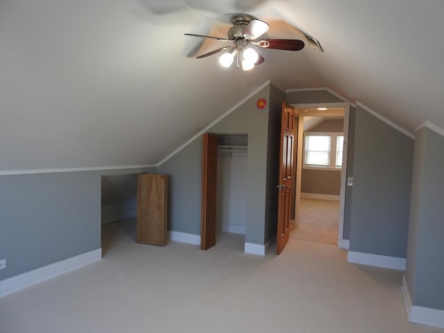 bonus room featuring vaulted ceiling, light carpet, and ceiling fan