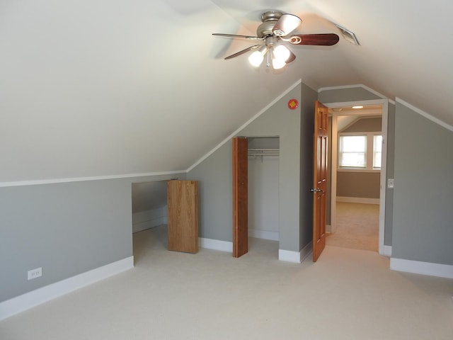 bonus room with lofted ceiling, light carpet, and ceiling fan