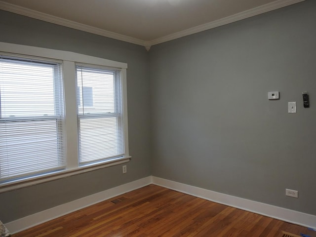 unfurnished room featuring hardwood / wood-style flooring and crown molding