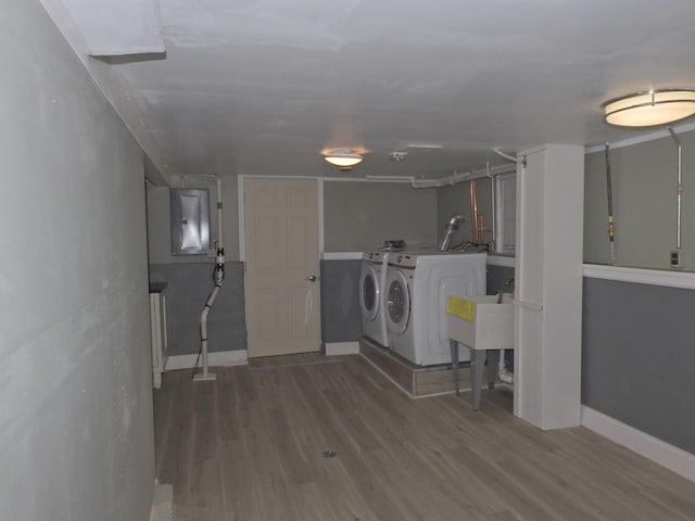 laundry room with wood-type flooring and independent washer and dryer