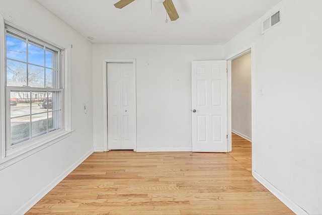 spare room with ceiling fan and light wood-type flooring