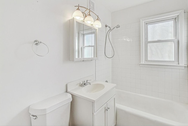 full bathroom featuring vanity, toilet, and tiled shower / bath combo