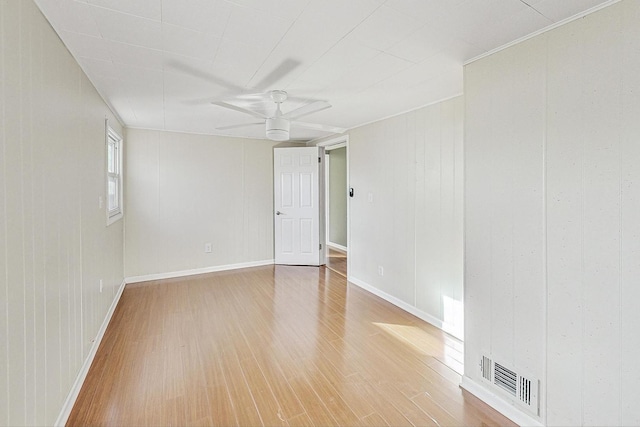 unfurnished room with hardwood / wood-style floors and ceiling fan