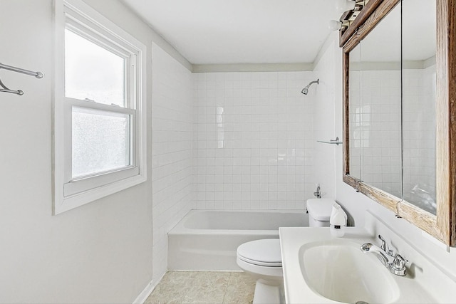 full bathroom featuring tiled shower / bath, sink, and toilet