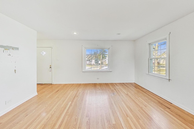 empty room with light hardwood / wood-style flooring