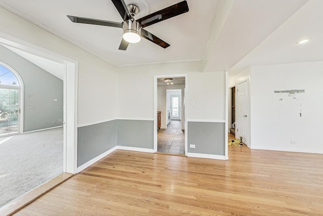 empty room featuring ceiling fan and light hardwood / wood-style floors