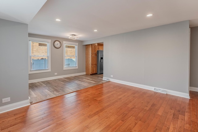 empty room with light hardwood / wood-style floors