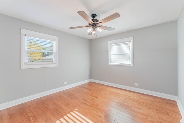 empty room with ceiling fan and light wood-type flooring