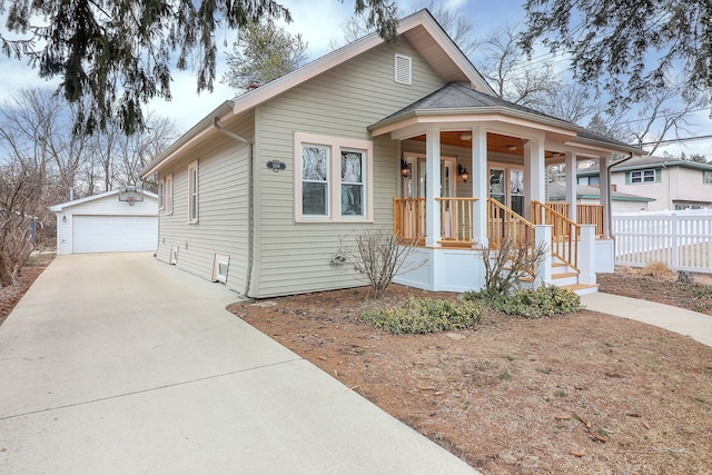 bungalow-style home with an outbuilding, a garage, and covered porch