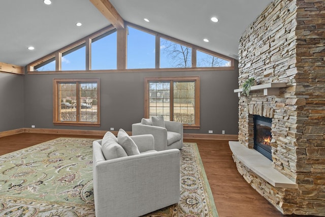 living room featuring hardwood / wood-style flooring, a fireplace, high vaulted ceiling, and beamed ceiling