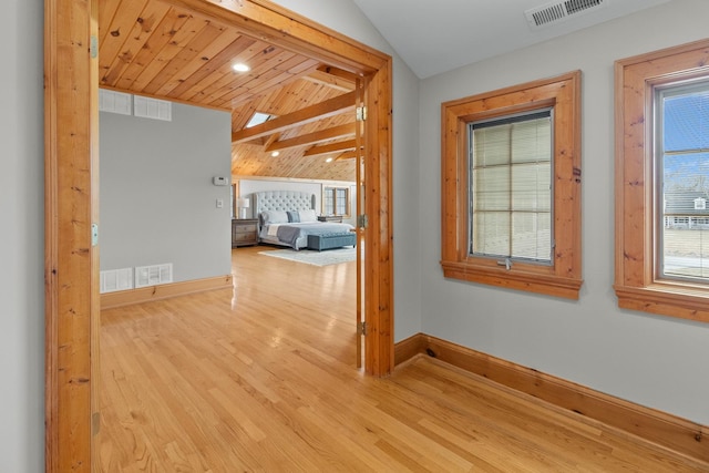 hallway with wood ceiling, light hardwood / wood-style floors, and vaulted ceiling with beams