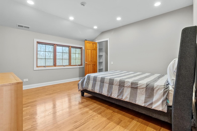 bedroom featuring vaulted ceiling and light hardwood / wood-style floors