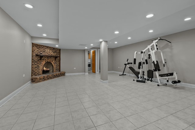 exercise area with a brick fireplace