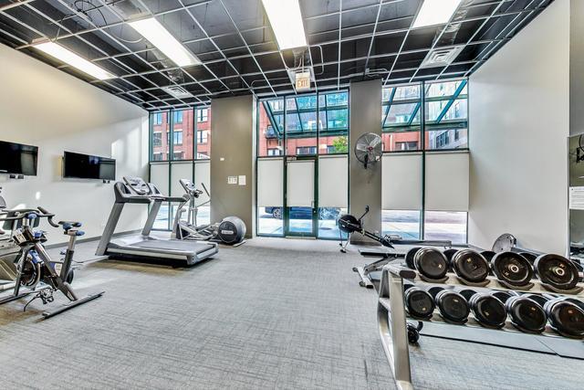 exercise room featuring carpet floors and floor to ceiling windows