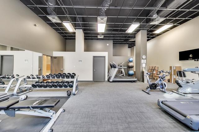 workout area featuring a towering ceiling