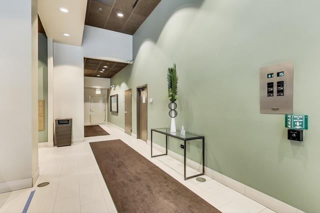 corridor featuring light tile patterned floors and a high ceiling