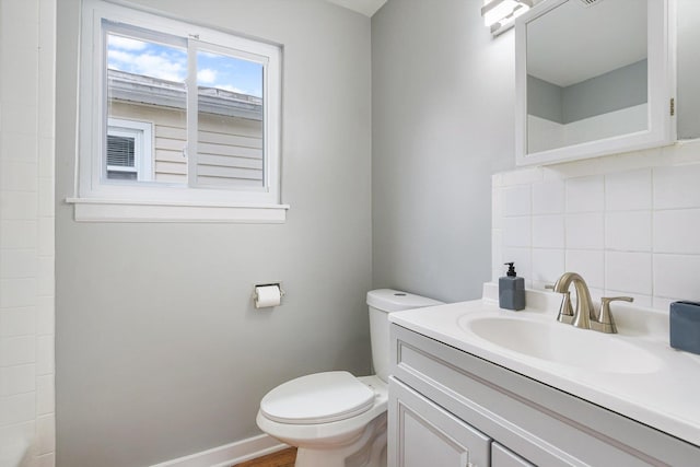 bathroom featuring tasteful backsplash, vanity, and toilet