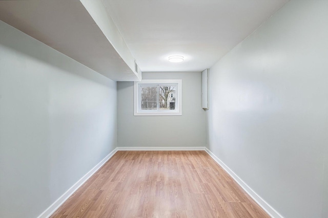 basement with light hardwood / wood-style floors