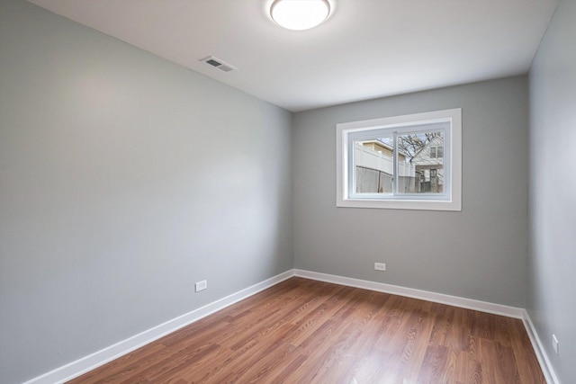 spare room with hardwood / wood-style flooring