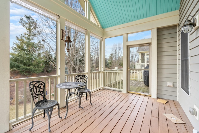 sunroom featuring vaulted ceiling