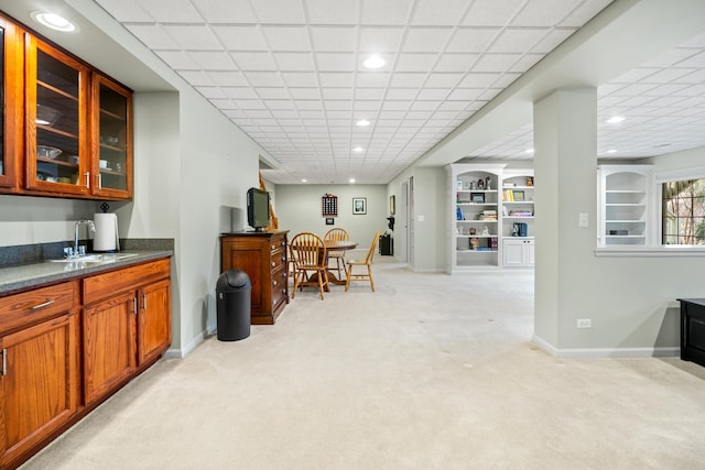 bar with light colored carpet, sink, and built in features