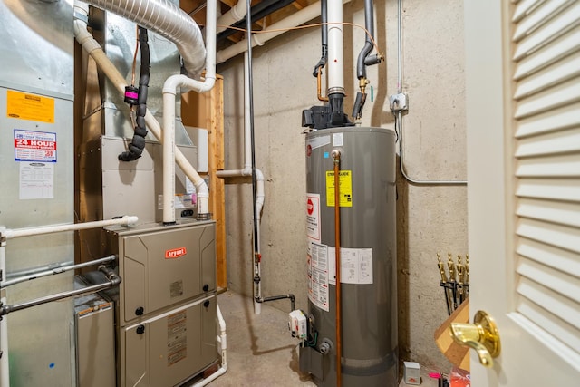 utility room with heating unit and gas water heater