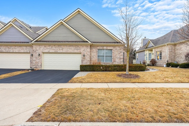 view of front of house with a garage and a front yard