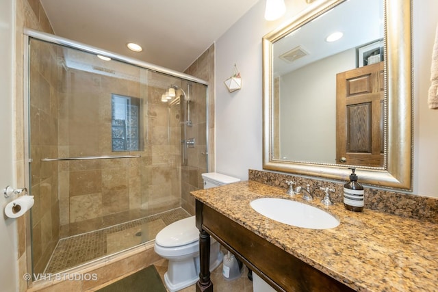 bathroom with vanity, an enclosed shower, and toilet