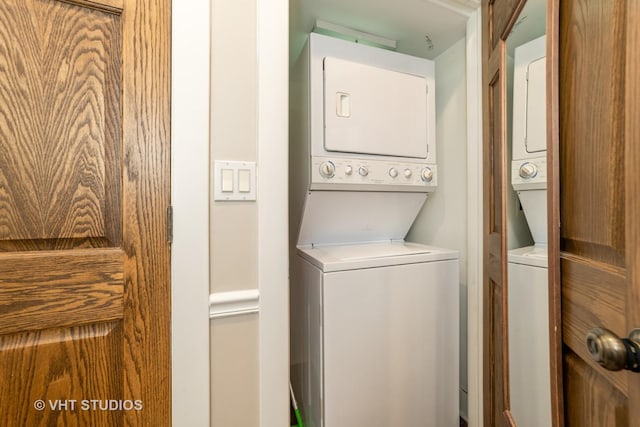 washroom featuring stacked washer and clothes dryer