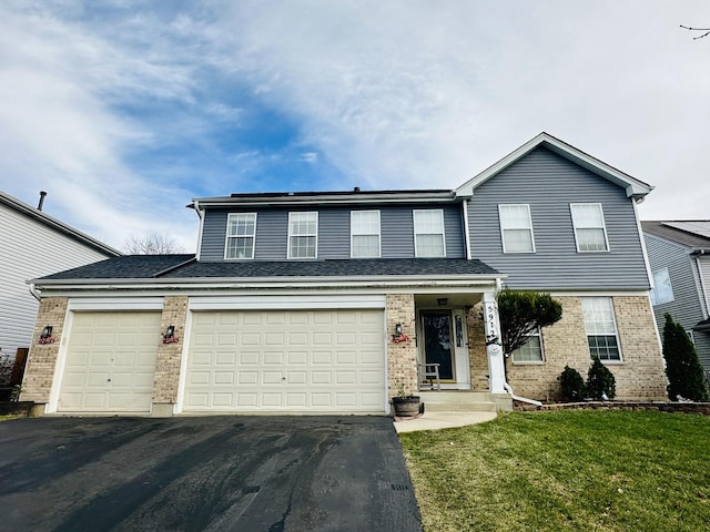 front facade with a garage and a front lawn