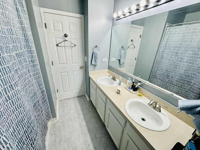 bathroom featuring walk in shower, vanity, and hardwood / wood-style floors