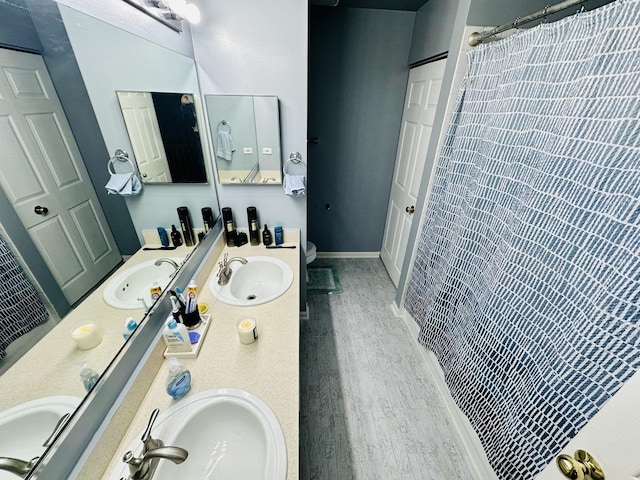 bathroom with wood-type flooring, curtained shower, vanity, and toilet