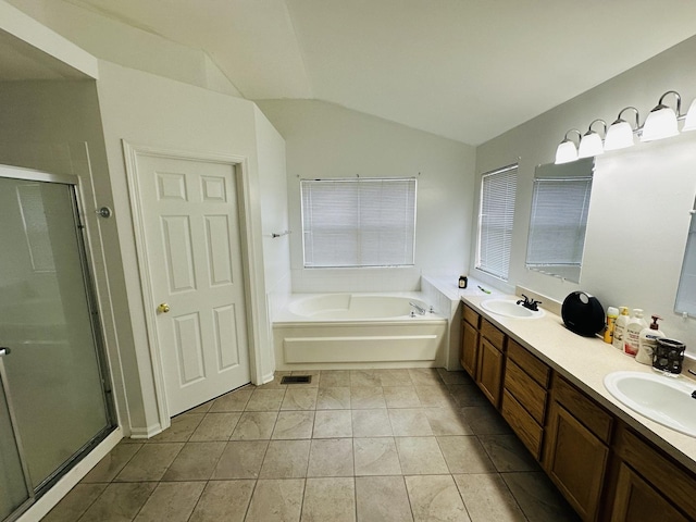 bathroom featuring vanity, lofted ceiling, tile patterned floors, and separate shower and tub