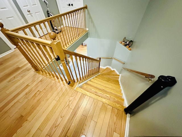 stairway with hardwood / wood-style flooring