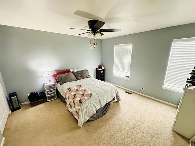 bedroom featuring light carpet and ceiling fan