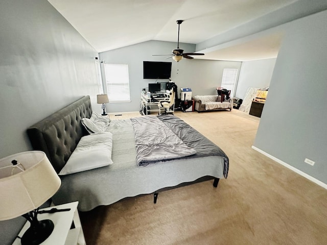 carpeted bedroom featuring lofted ceiling and ceiling fan