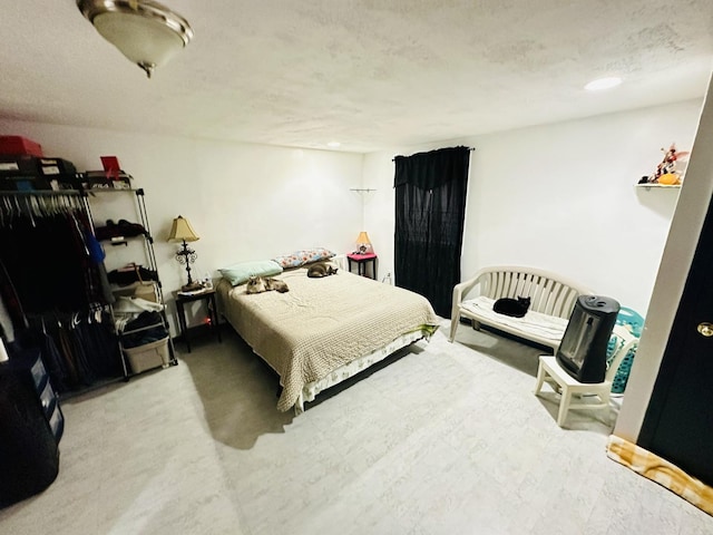 carpeted bedroom with a textured ceiling