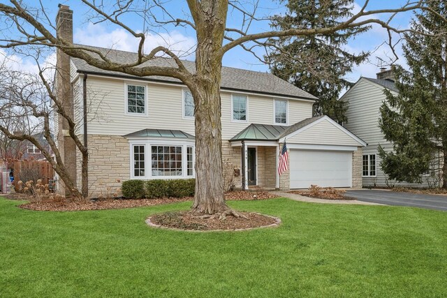 front facade featuring a garage and a front yard