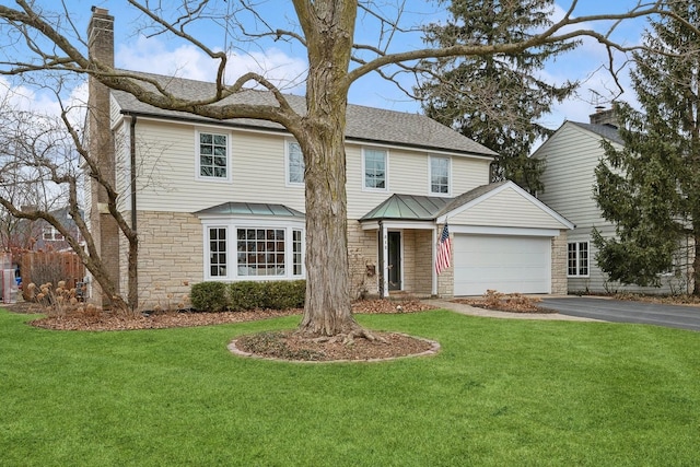 view of front property with a garage and a front lawn