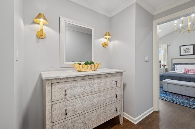 bathroom featuring ornamental molding, a chandelier, hardwood / wood-style floors, and vanity