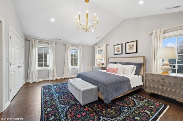 bedroom with vaulted ceiling, a chandelier, and dark hardwood / wood-style flooring