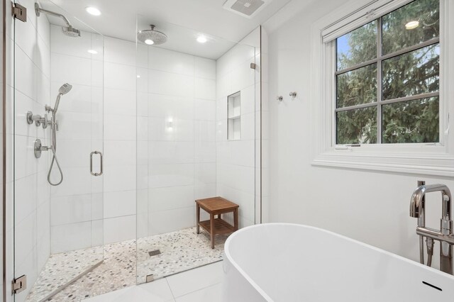 bathroom with tile patterned flooring, separate shower and tub, and sink