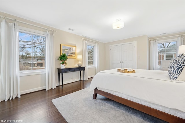 bedroom with dark hardwood / wood-style flooring