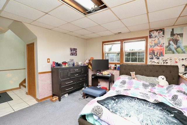 carpeted bedroom with a paneled ceiling