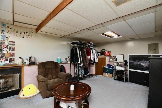 interior space featuring light carpet, a fireplace, and a paneled ceiling