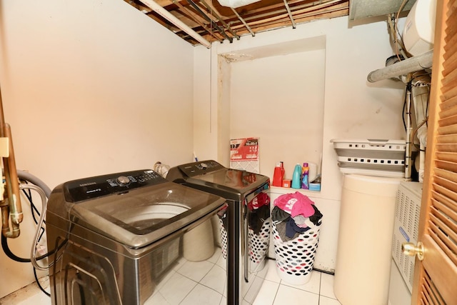 washroom with light tile patterned floors and washer and clothes dryer