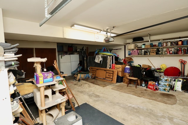 garage featuring a garage door opener and white fridge